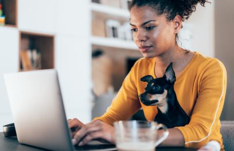 woman with dog at laptop