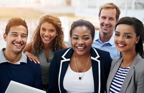 People of color in office wear smiling