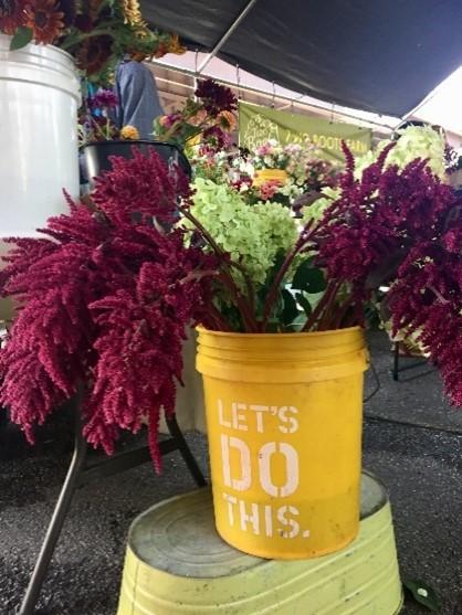yellow bucket with wildflowers