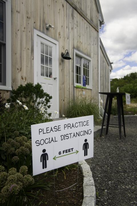 social distance sign outside of emery farm