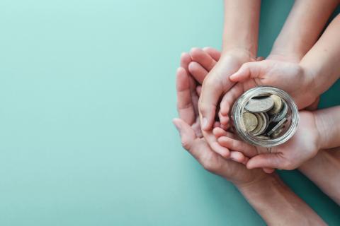 Family hands holding coins