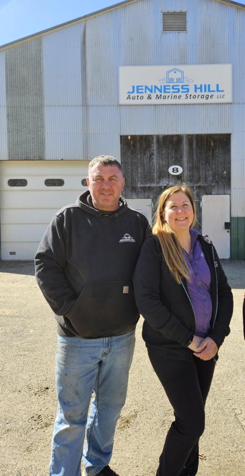 Jerry & Andrea Harper standing in front of their business, Jenness Hill Auto & Marine Storage
