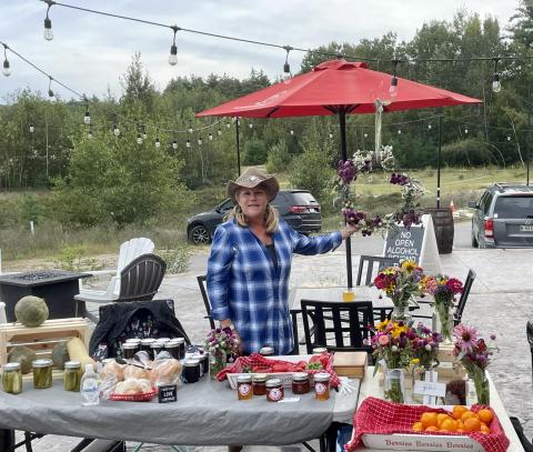 Laurianne Bennet hosting a table at a farmer's market